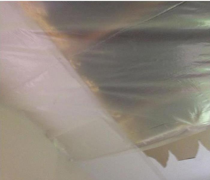 plastic sheeting over opening in ceiling