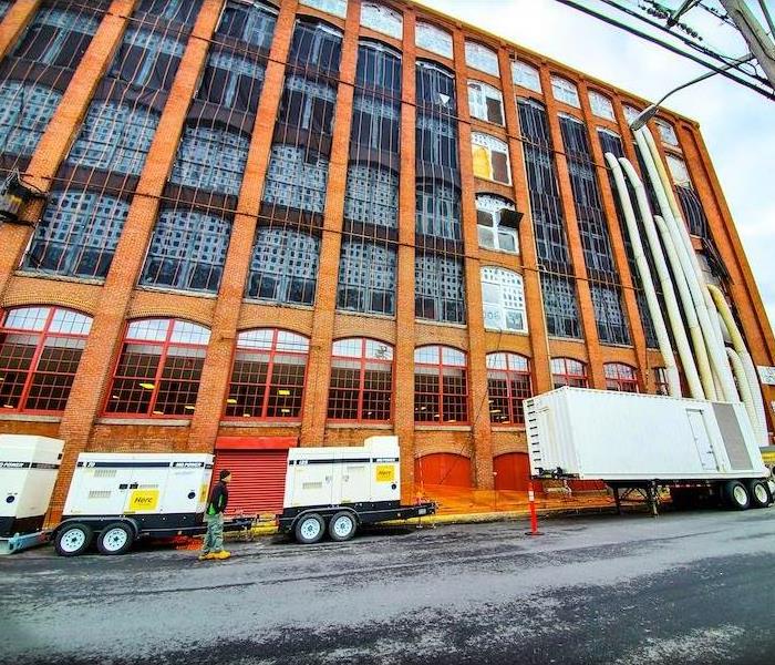 SERVPRO equipment in front of large older building